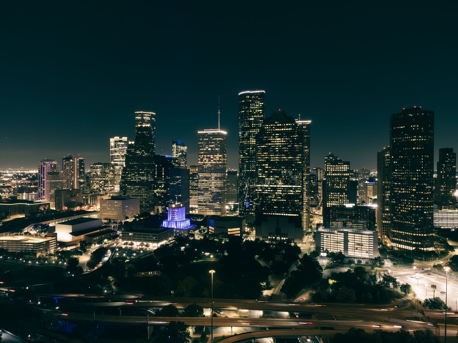 illuminated skyscrapers and roads in night city
