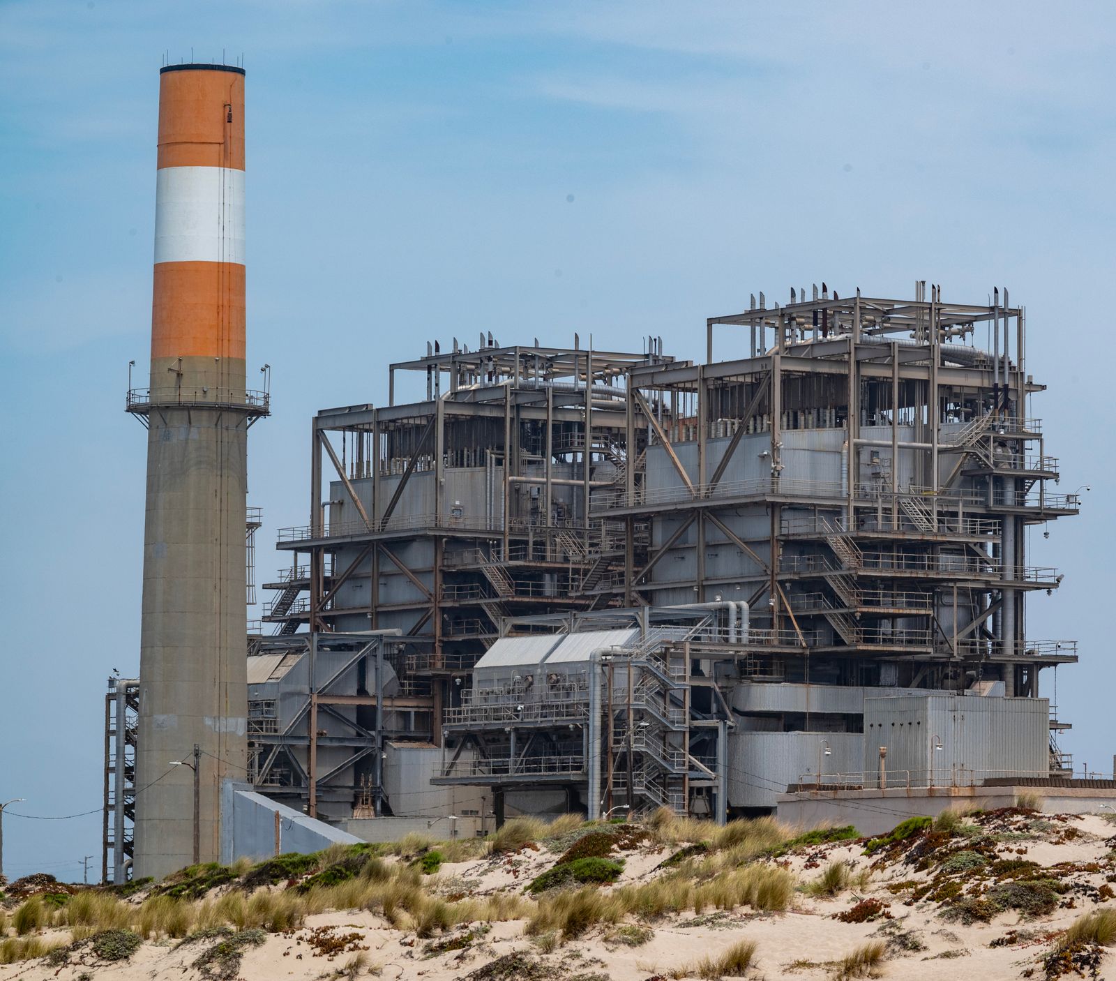 a large industrial plant with a chimney on top