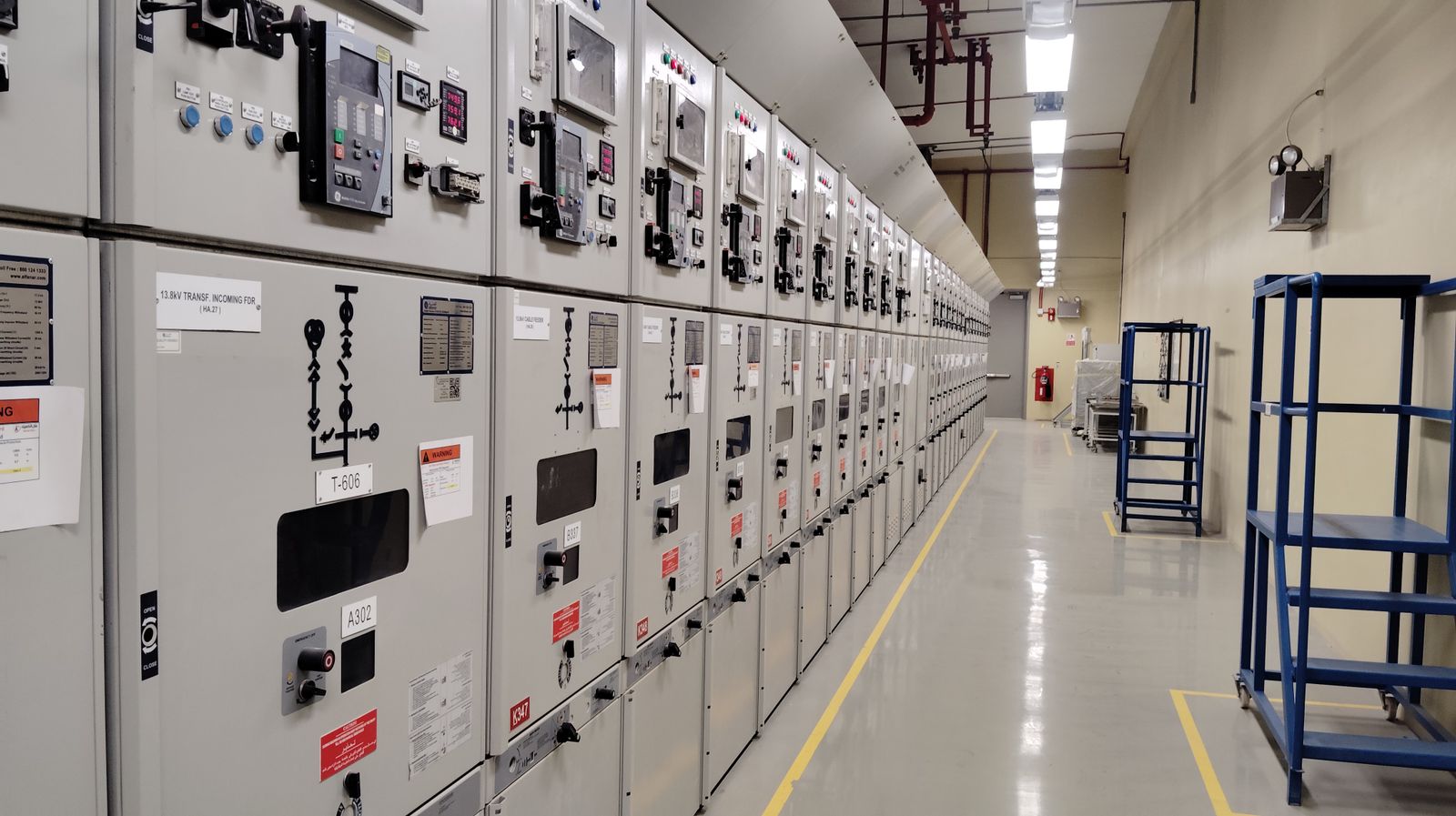 Engineers working in an industrial electrical control room